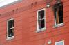 MIKE DEAL / FREE PRESS
                                A contractor measures one of the damaged window frames at 285 College Ave. where a fire was reported at 7:29 a.m. Thursday.